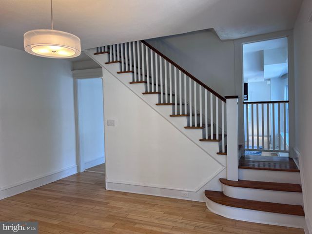 a living room with kitchen island granite countertop wooden floor
