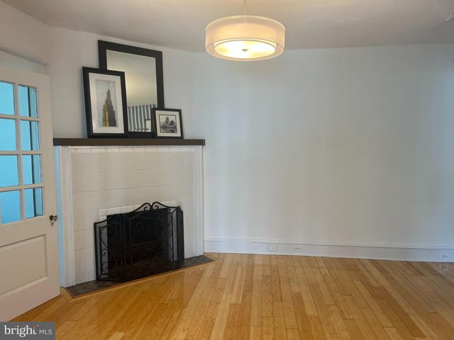 a view of a livingroom with a fireplace and wooden floor