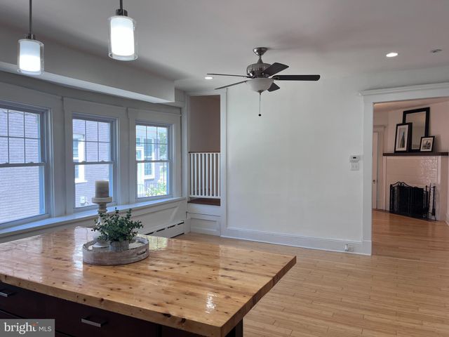 a kitchen with kitchen island granite countertop a sink counter top space cabinets and stainless steel appliances