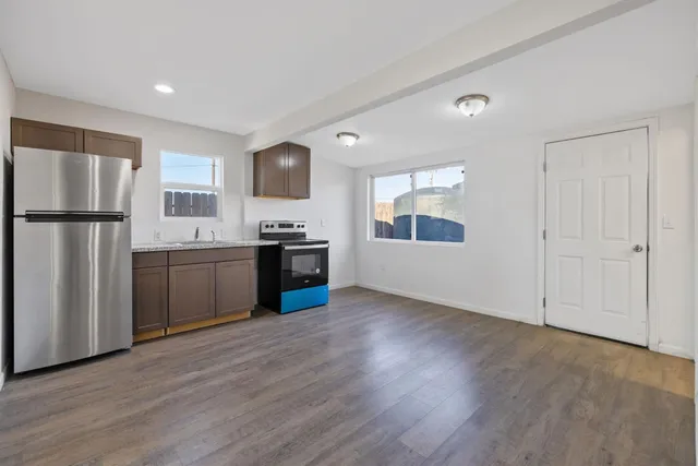 a kitchen with stainless steel appliances granite countertop a refrigerator sink and stove