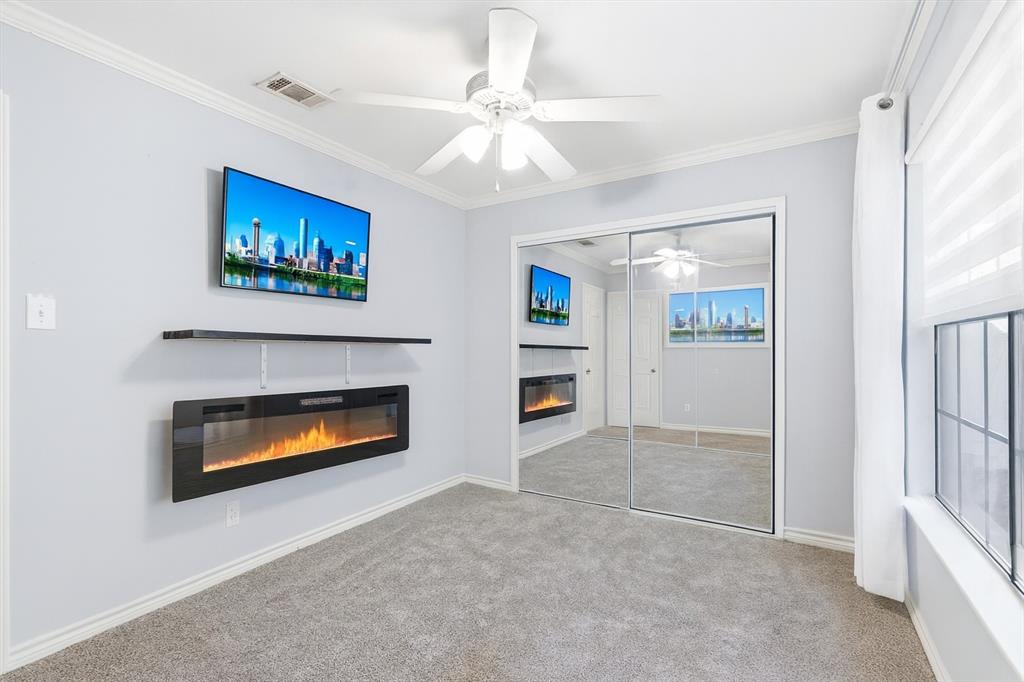 4020 Windhaven Lane Dallas, TX 75287 - Photo 19 of 32 an empty room with fireplace and fan