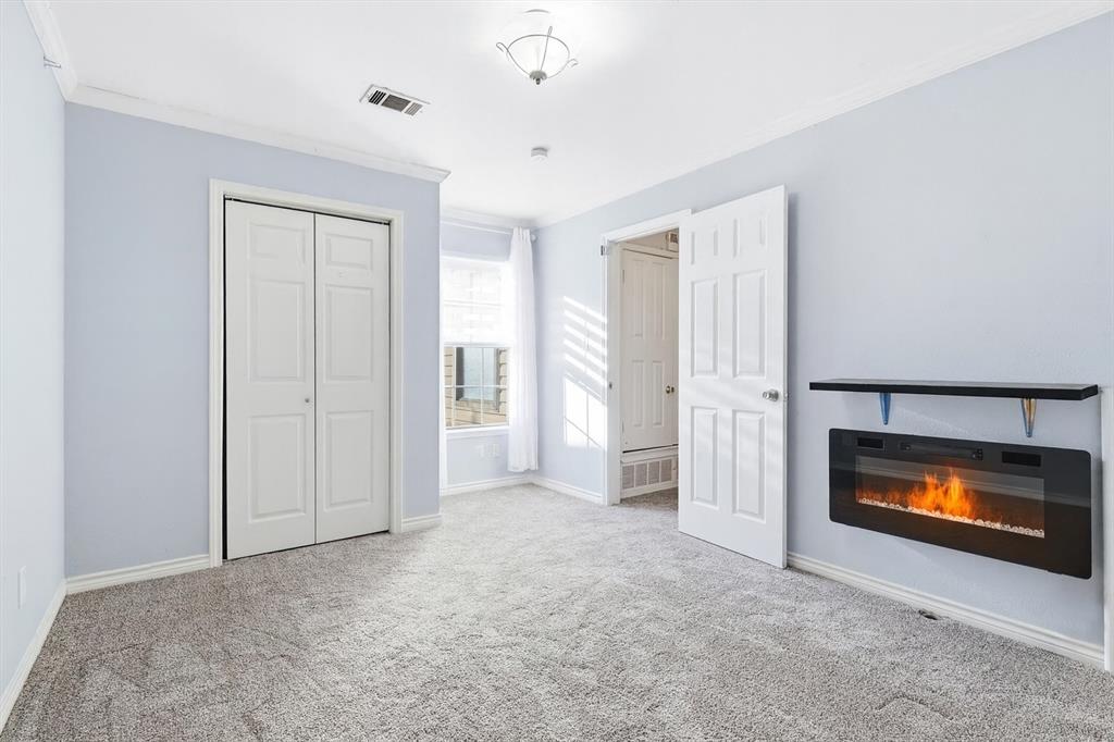 4020 Windhaven Lane Dallas, TX 75287 - Photo 21 of 32 a view of an empty room with a fireplace and a window