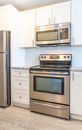 a stove top oven sitting inside of a kitchen