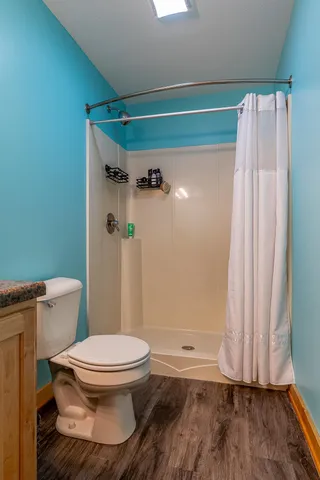 a bathroom with a sink a toilet and mirror