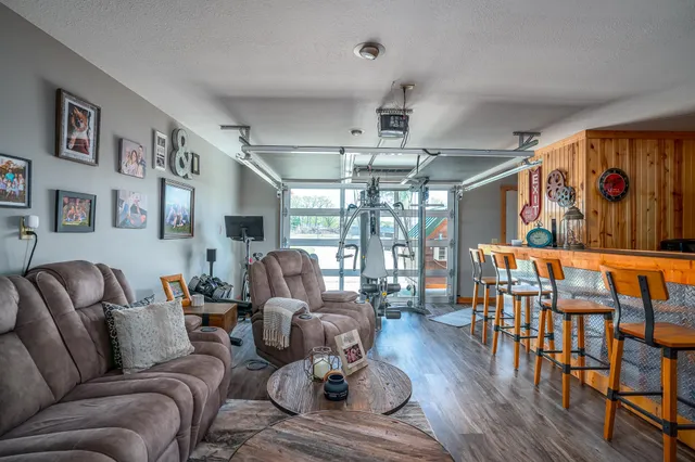 a living room with furniture a couch and wooden floor