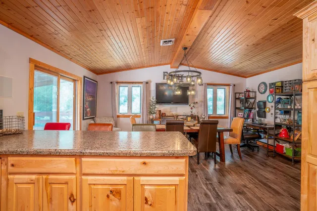 a kitchen with stainless steel appliances granite countertop a sink a stove and cabinets