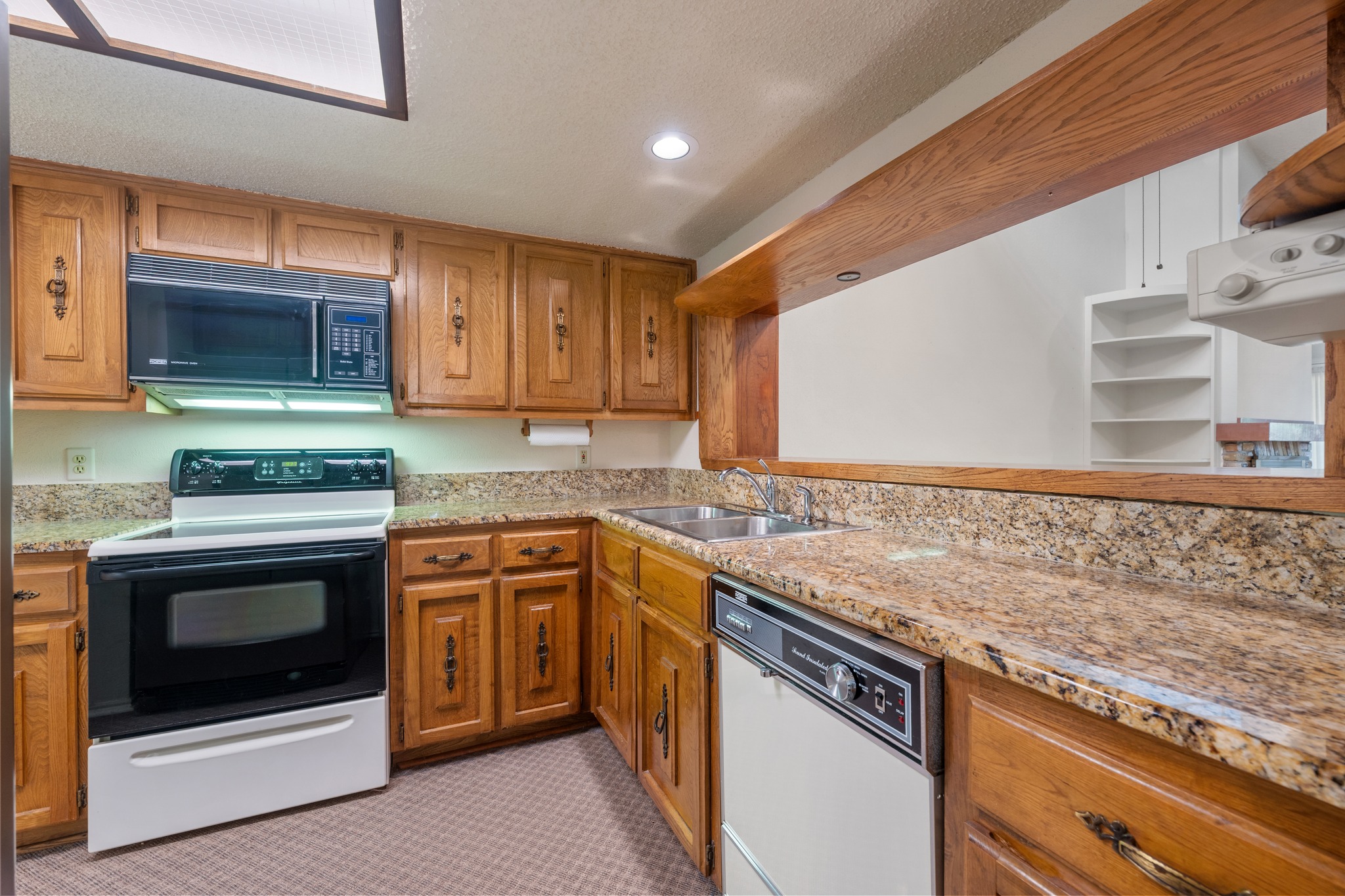 8318 Bent Tree Road Austin, TX 78759 - Photo 12 of 37 The kitchen features wood cabinetry and updated granite countertops