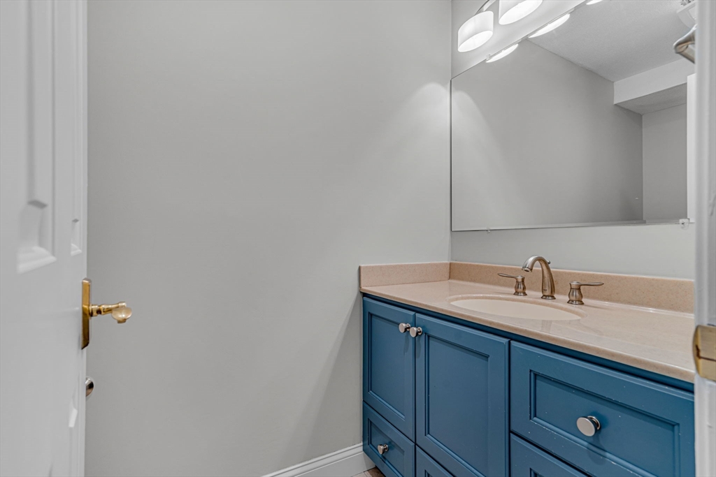 403 Great Road, Unit 5 Acton, MA 01720 - Photo 14 of 25 a bathroom with a sink and vanity