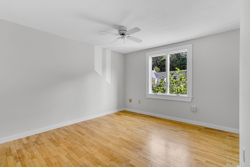 403 Great Road, Unit 5 Acton, MA 01720 - Photo 17 of 25 wooden floor in an empty room with a window