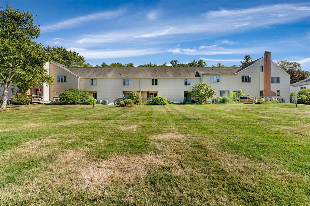 403 Great Road, Unit 5 Acton, MA 01720 - Photo 3 of 25 a view of a patio with a big yard