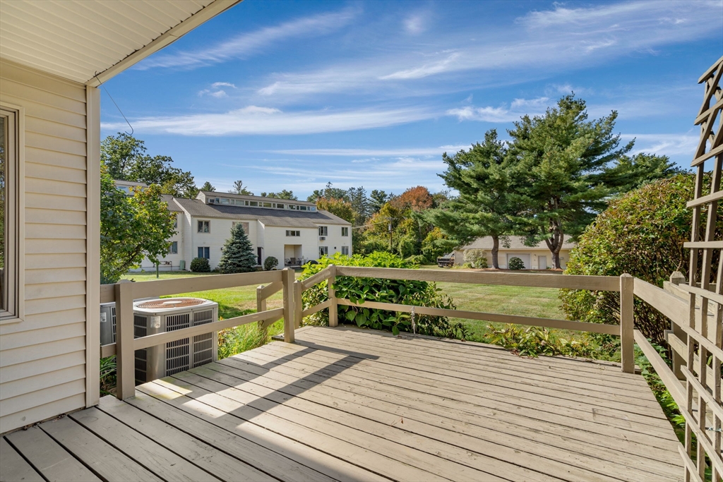 403 Great Road, Unit 5 Acton, MA 01720 - Photo 4 of 25 a view of a wooden deck and a yard