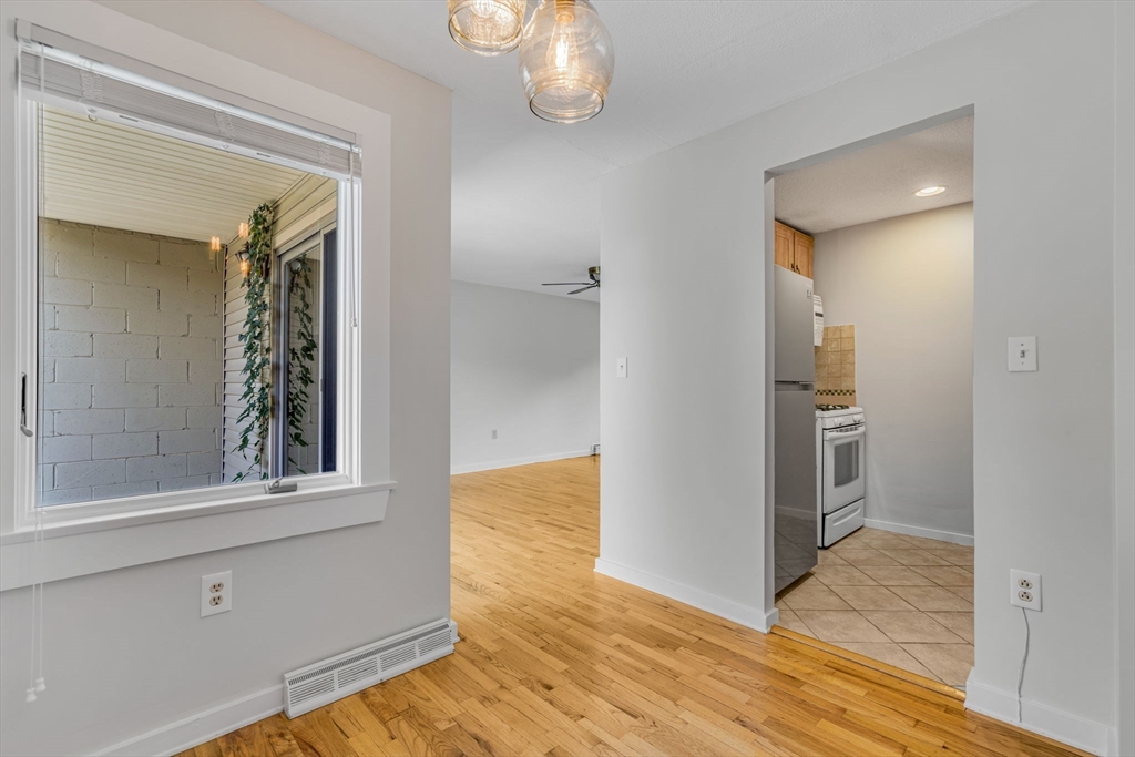 403 Great Road, Unit 5 Acton, MA 01720 - Photo 10 of 25 a view of a hallway with wooden floor and closet