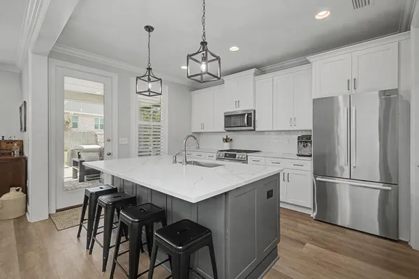 a kitchen with appliances cabinets a counter space and wooden floor