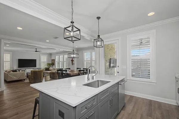 a kitchen with sink stove top oven and refrigerator