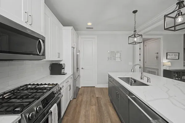a kitchen with stainless steel appliances granite countertop a sink stove and refrigerator