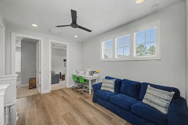 a living room with furniture a window and a flat screen tv