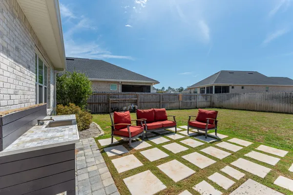 a backyard of a house with barbeque oven