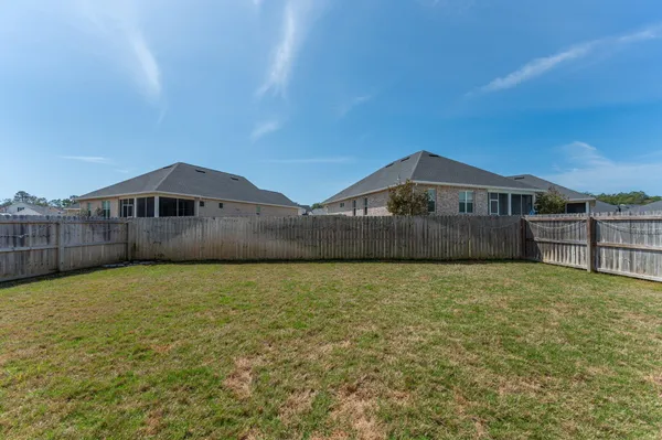 a view of a house with backyard porch and sitting area