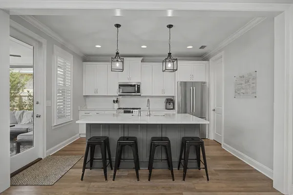 a large white kitchen with a table and chairs