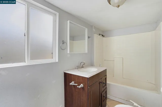a bathroom with a sink a mirror and a bathtub