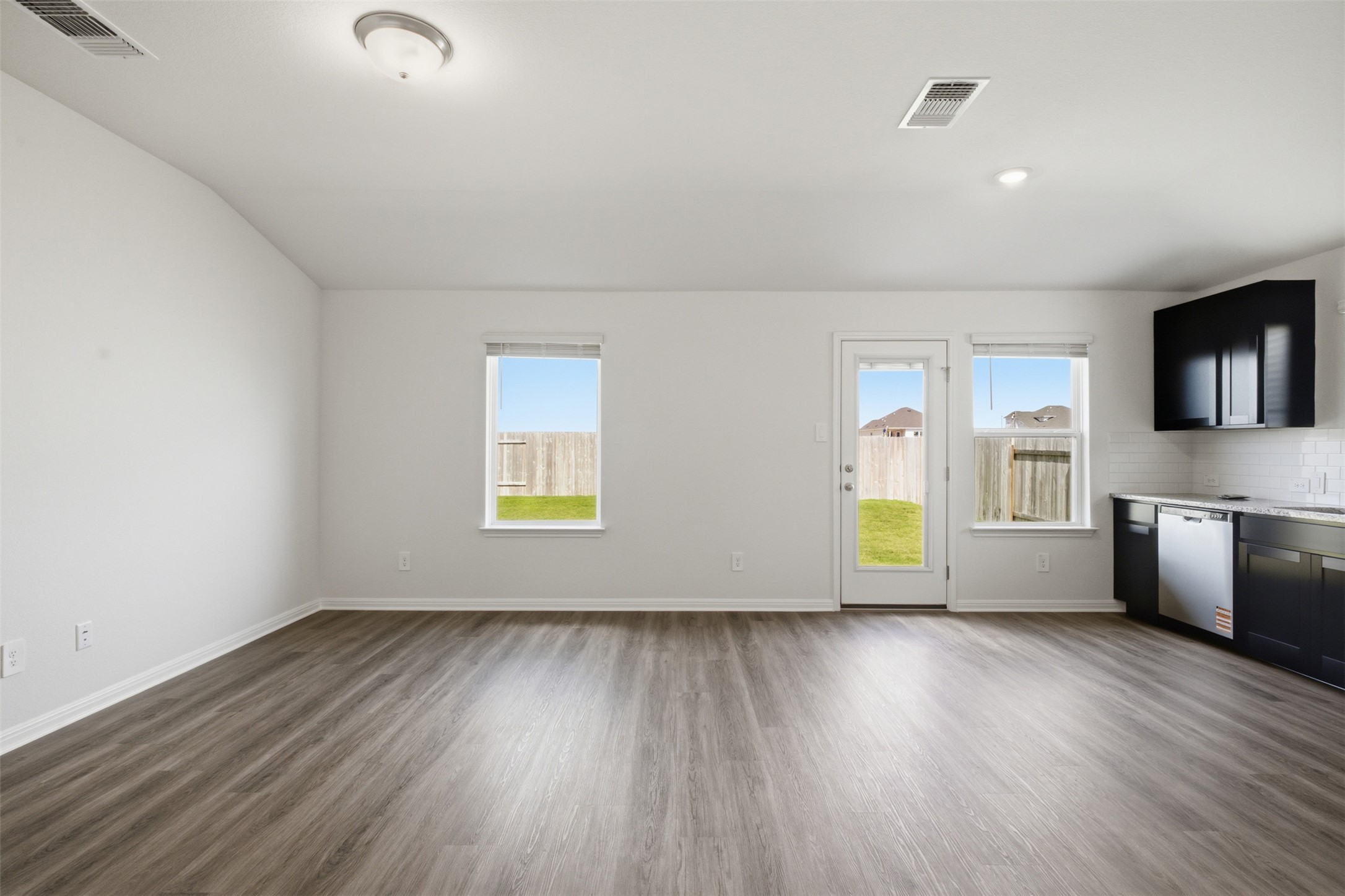 121 Honey Bee Road Jarrell, TX 76537 - Photo 5 of 25 an empty room with wooden floor and windows