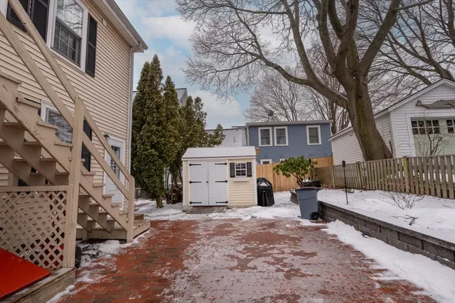 a view of a house with a yard covered in snow