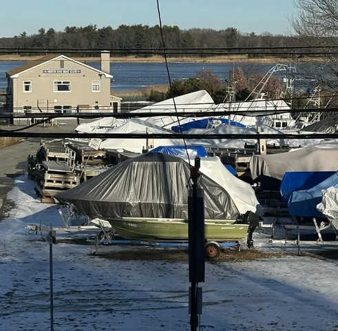 a view of a roof deck with table and chairs with wooden floor