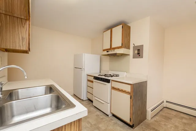 a kitchen with granite countertop a sink and a stove top oven