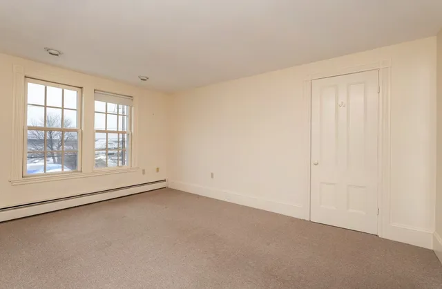 an empty room with a empty space and windows