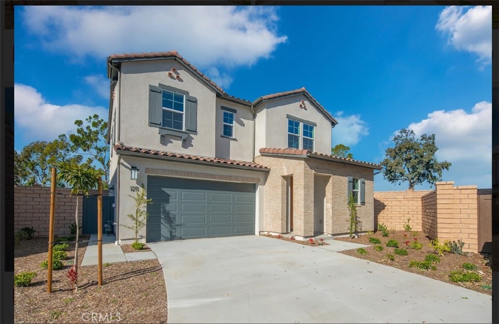 a front view of a house with a garden and yard