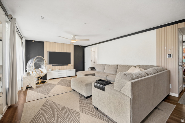 1215 8th Street Ogden, UT 84404 - Photo 5 of 39 Living area featuring wood-finish flooring, a contemporary accent wall with vertical slat paneling, and a ceiling fan with integrated lighting