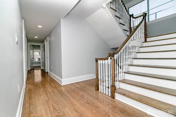 a view of entryway with wooden floor and stairs