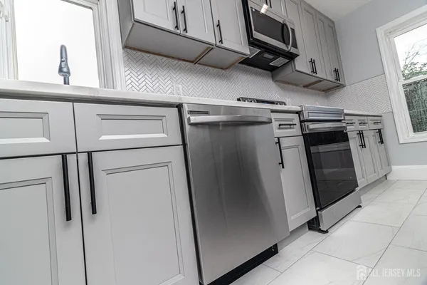 a view of a kitchen with stainless steel appliances and a window