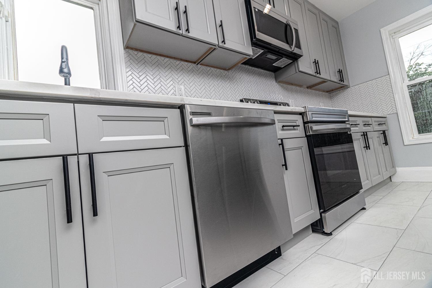 10 Codington Place, Unit 2 Somerville, NJ 08876 - Photo 4 of 14 a view of a kitchen with stainless steel appliances and a window