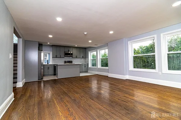 a view of kitchen with wooden floor electronic appliances and window