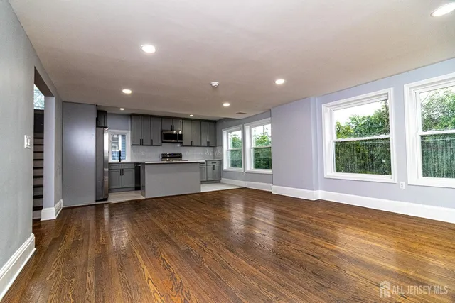 a view of kitchen with wooden floor electronic appliances and window