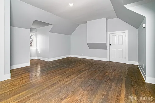 an empty room with wooden floor and closet