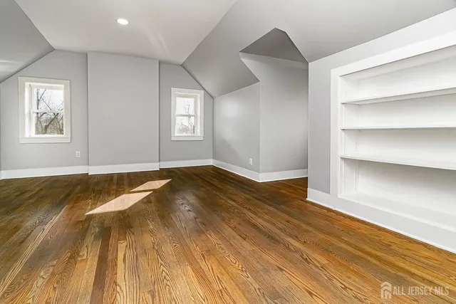 a view of a room with wooden floor and window