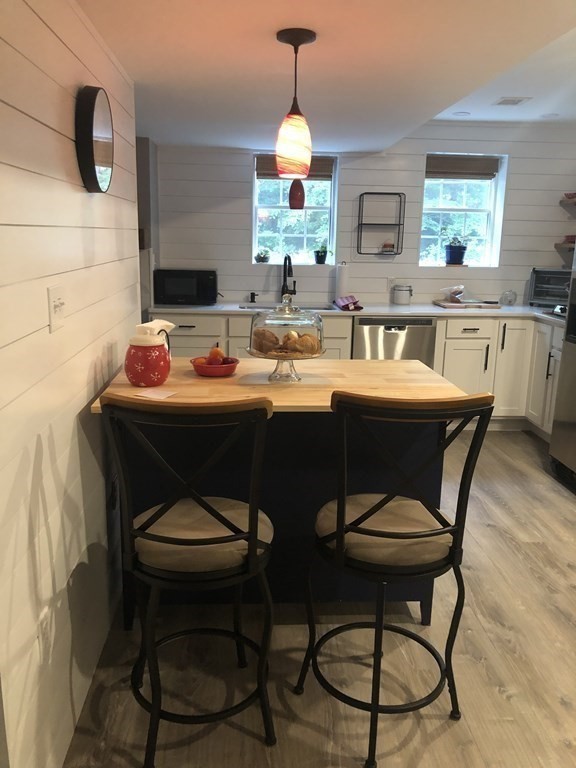 1 Park Road, Unit 1 Sandwich, MA 02644 - Photo 16 of 25 a dining room with a chandelier and a wooden floor