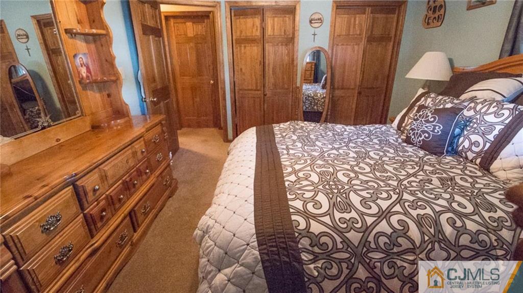 15 Eastlick Road Edison, NJ 08817 - Photo 18 of 23 a bedroom with a bed and a large mirror on the dresser