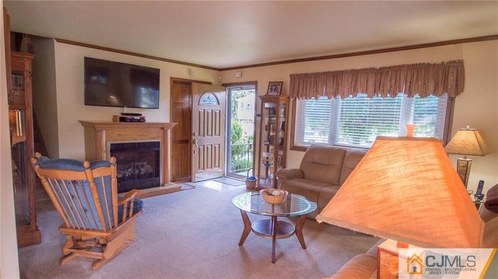 15 Eastlick Road Edison, NJ 08817 - Photo 5 of 23 a living room with furniture a flat screen tv and a fireplace