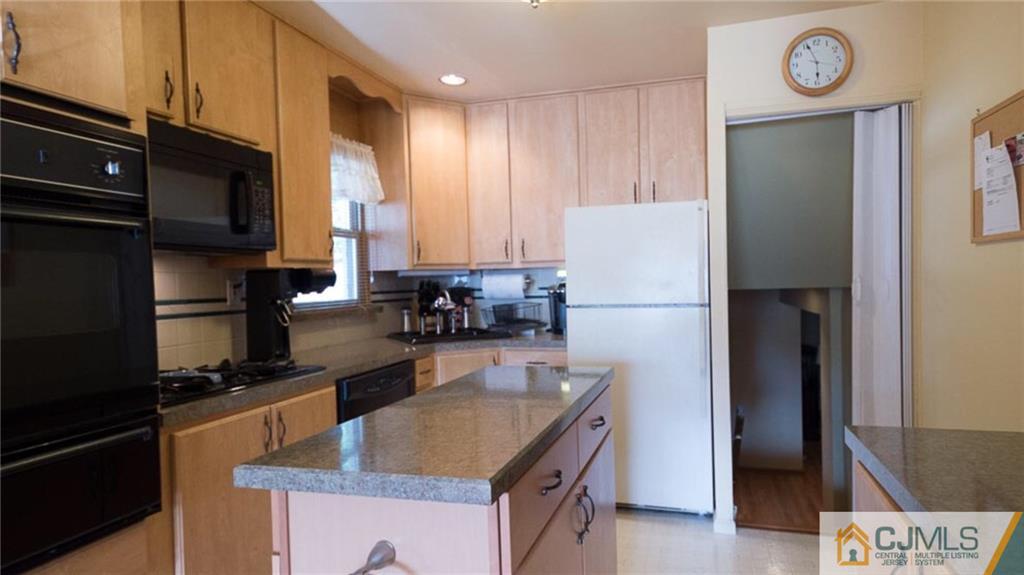15 Eastlick Road Edison, NJ 08817 - Photo 6 of 23 a kitchen with a refrigerator a stove top oven a sink and dishwasher