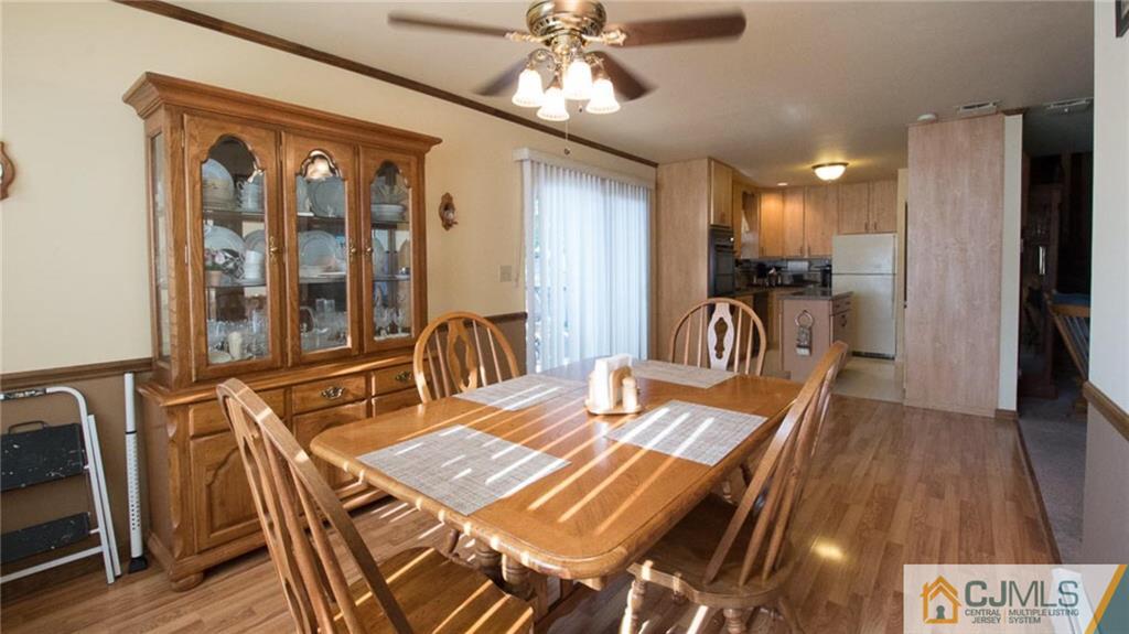 15 Eastlick Road Edison, NJ 08817 - Photo 8 of 23 a view of a dining room with furniture a chandelier and wooden floor