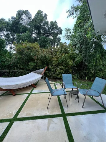 a view of a chairs and tables in the back yard of the house