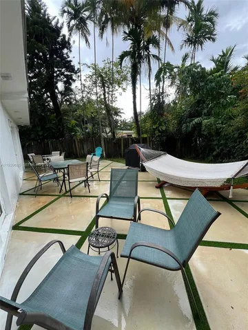 a view of patio with swimming pool table and chairs