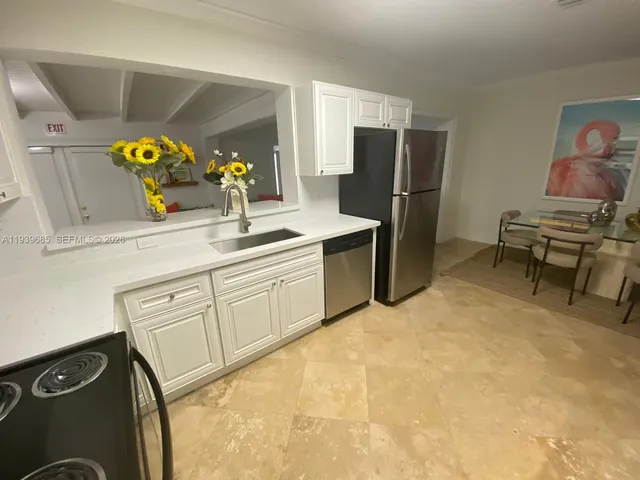 a kitchen with a sink appliances and cabinets