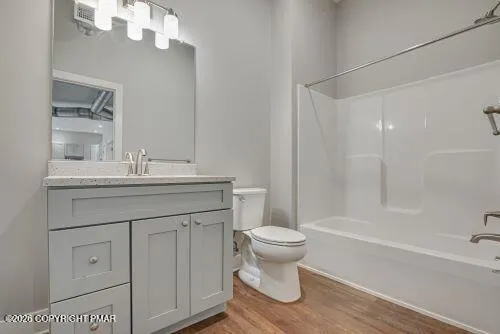 a bathroom with a sink toilet a mirror and shower