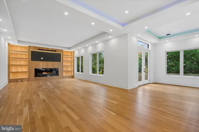 an empty room with a fireplace and window