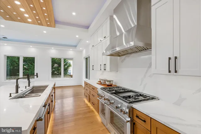 a kitchen with stainless steel appliances granite countertop a stove and a sink