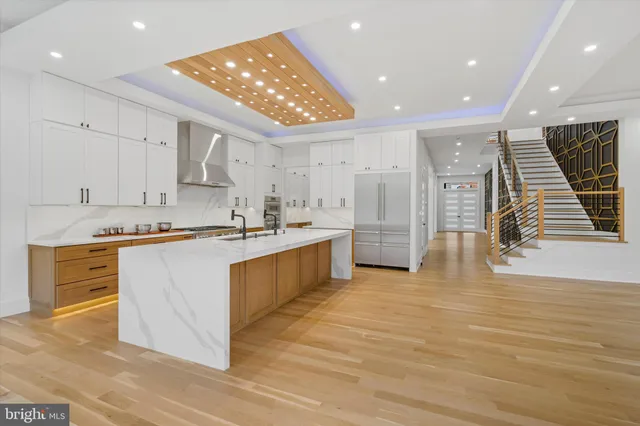 a large kitchen with stainless steel appliances kitchen island granite countertop a large counter top and a stove